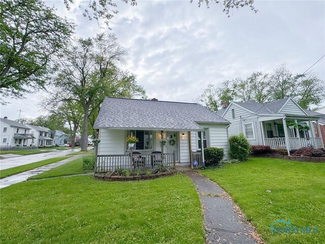 4635 Vermaas Ave, Toledo, OH 43612 - bungalow-style house featuring a porch, a front lawn, and roof with shingles