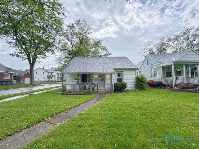 4635 Vermaas Ave, Toledo, OH 43612 - bungalow-style house featuring covered porch, a front lawn, and roof with shingles