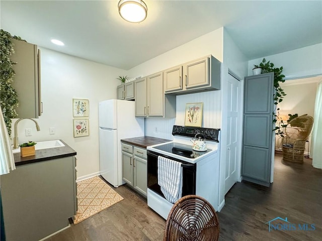 4635 Vermaas Ave, Toledo, OH 43612 - kitchen with electric stove, a sink, dark countertops, dark wood finished floors, and recessed lighting