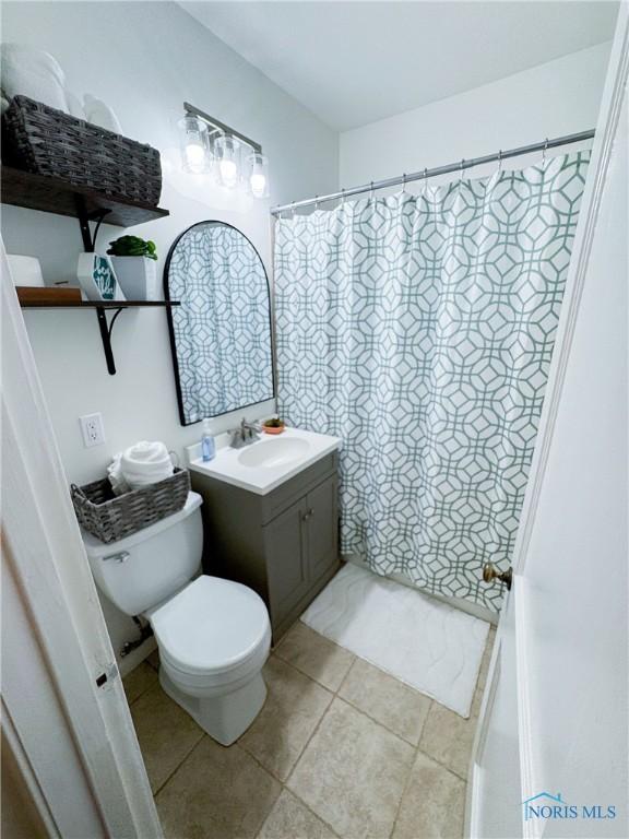 4635 Vermaas Ave, Toledo, OH 43612 - full bathroom with toilet, vanity, and tile patterned floors
