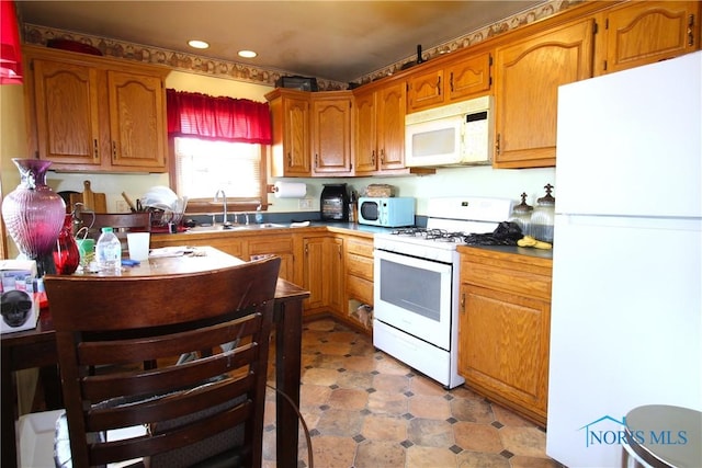 905 Eleanor Ave, Toledo, OH 43612 - kitchen featuring white appliances, a sink, recessed lighting, brown cabinetry, and light flooring
