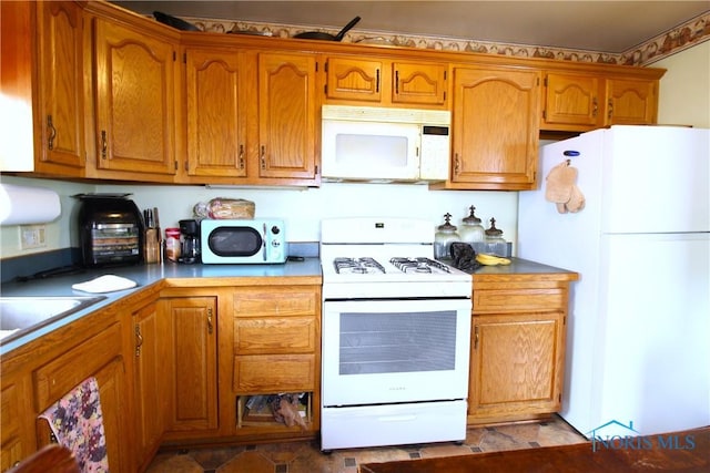 905 Eleanor Ave, Toledo, OH 43612 - kitchen with white appliances and brown cabinets