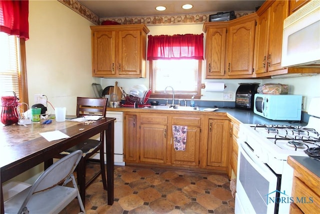905 Eleanor Ave, Toledo, OH 43612 - kitchen with white appliances, a sink, brown cabinets, and recessed lighting