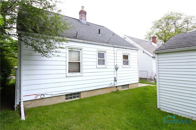905 Eleanor Ave, Toledo, OH 43612 - back of house featuring a lawn, a chimney, and roof with shingles