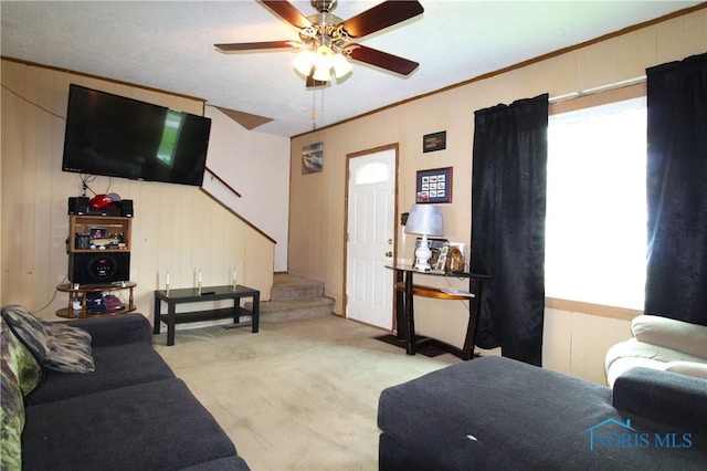 2544 110th St, Toledo, OH 43611 - living room featuring stairs, light carpet, ceiling fan, and wood walls