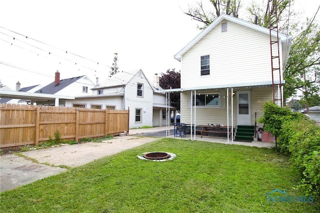 2544 110th St, Toledo, OH 43611 - rear view of house with entry steps, a fire pit, and a patio area
