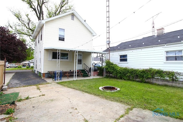 2544 110th St, Toledo, OH 43611 - back of house featuring entry steps, a yard, and an outdoor fire pit