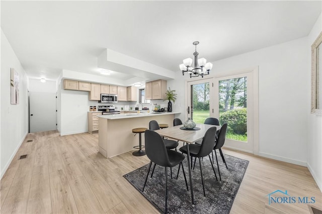 3407 Waterville Swanton Rd, Swanton, OH 43558 - dining room featuring a chandelier, light wood-type flooring, and baseboards