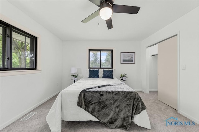 3407 Waterville Swanton Rd, Swanton, OH 43558 - bedroom with multiple windows, light colored carpet, baseboards, and a ceiling fan