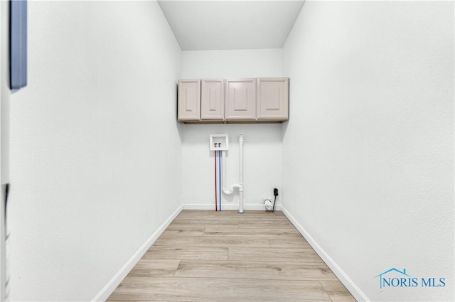 3407 Waterville Swanton Rd, Swanton, OH 43558 - laundry room with cabinet space, washer hookup, light wood-style floors, and baseboards