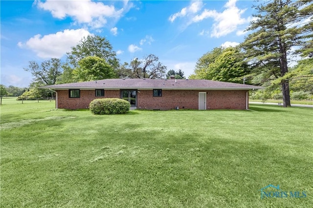 3407 Waterville Swanton Rd, Swanton, OH 43558 - rear view of house featuring a lawn and brick siding