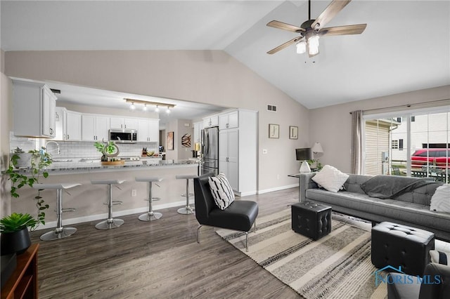 819 Wood Sorrel Ln, Perrysburg, OH 43551 - living room featuring dark wood-style flooring, a ceiling fan, vaulted ceiling, and baseboards