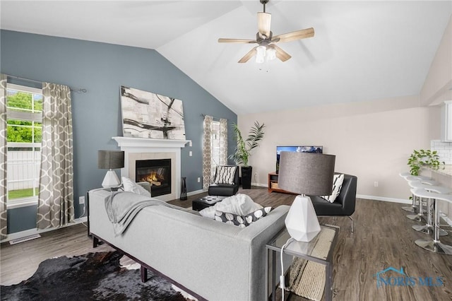 819 Wood Sorrel Ln, Perrysburg, OH 43551 - living room featuring vaulted ceiling, ceiling fan, a fireplace, wood finished floors, and baseboards
