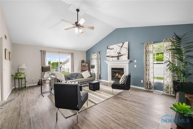 819 Wood Sorrel Ln, Perrysburg, OH 43551 - living room with ceiling fan, wood finished floors, lofted ceiling, a fireplace, and baseboards