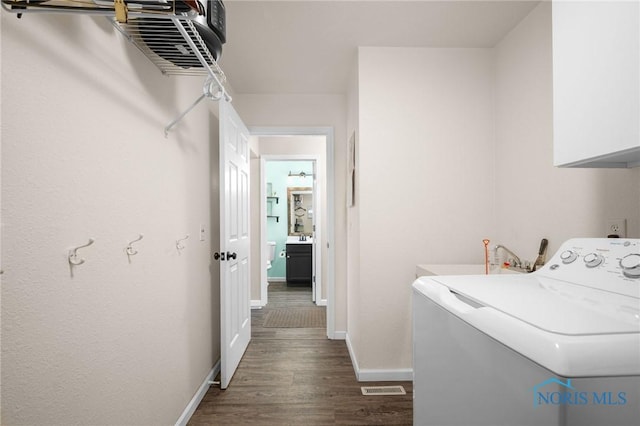 819 Wood Sorrel Ln, Perrysburg, OH 43551 - laundry area featuring washer / clothes dryer, cabinet space, dark wood-style flooring, and baseboards