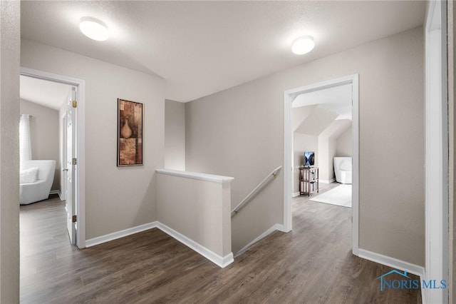 819 Wood Sorrel Ln, Perrysburg, OH 43551 - corridor with an upstairs landing, dark wood finished floors, and baseboards