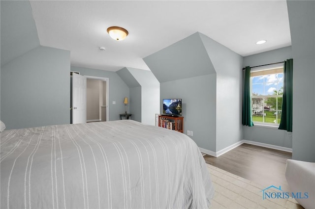 819 Wood Sorrel Ln, Perrysburg, OH 43551 - bedroom featuring wood finished floors, vaulted ceiling, and baseboards