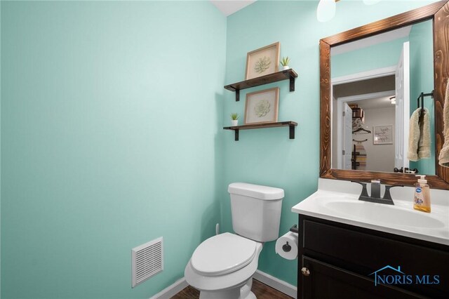 819 Wood Sorrel Ln, Perrysburg, OH 43551 - bathroom featuring toilet, vanity, baseboards, and wood finished floors