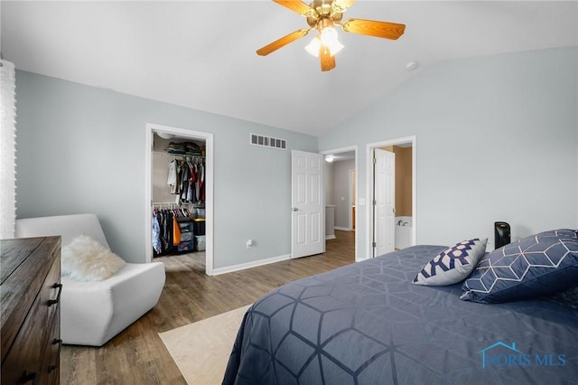 819 Wood Sorrel Ln, Perrysburg, OH 43551 - bedroom featuring lofted ceiling, wood finished floors, a walk in closet, a closet, and baseboards