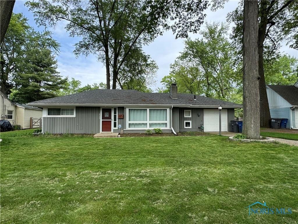 2730 W Rockridge Cir, Toledo, OH 43606 - ranch-style home with an attached garage, a chimney, and a front lawn