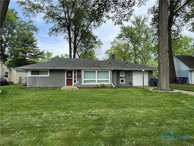 2730 W Rockridge Cir, Toledo, OH 43606 - ranch-style home with an attached garage, a chimney, and a front lawn
