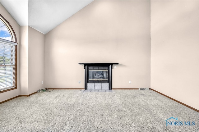 7195 Twin Lakes Rd, Perrysburg, OH 43551 - unfurnished living room featuring healthy amount of natural light, lofted ceiling, carpet, a fireplace with flush hearth, and baseboards