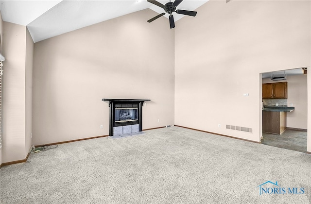 7195 Twin Lakes Rd, Perrysburg, OH 43551 - unfurnished living room with high vaulted ceiling, a ceiling fan, light colored carpet, baseboards, and a tiled fireplace