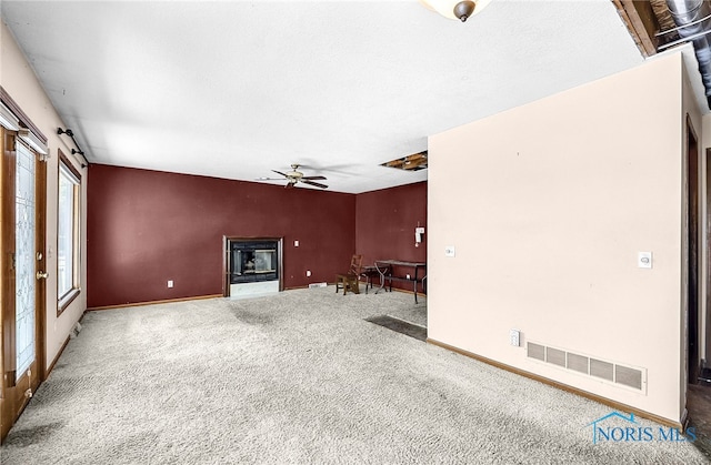 7195 Twin Lakes Rd, Perrysburg, OH 43551 - unfurnished living room with ceiling fan, carpet floors, baseboards, and a glass covered fireplace