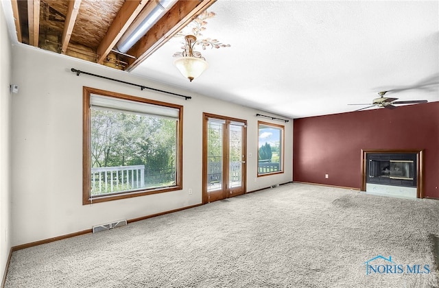 7195 Twin Lakes Rd, Perrysburg, OH 43551 - unfurnished living room featuring healthy amount of natural light, a fireplace with flush hearth, and carpet floors