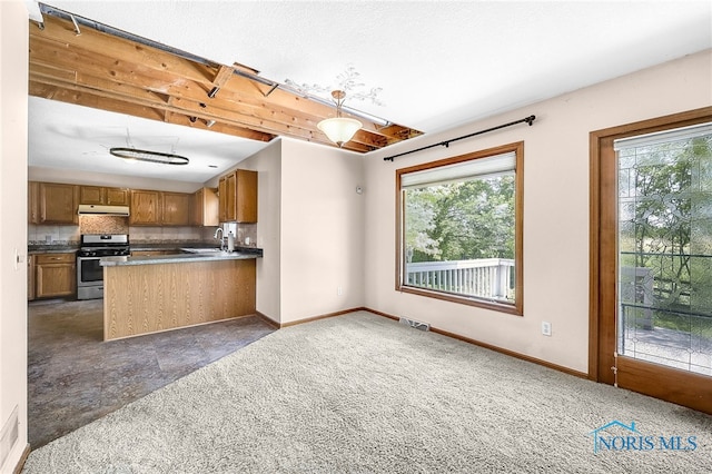 7195 Twin Lakes Rd, Perrysburg, OH 43551 - kitchen featuring stainless steel range, under cabinet range hood, brown cabinetry, a sink, and open floor plan