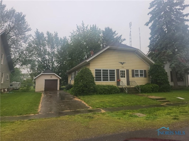 104 E S St, Middle Point, OH 45863 - view of front of property featuring a detached garage, an outdoor structure, a front yard, and concrete driveway