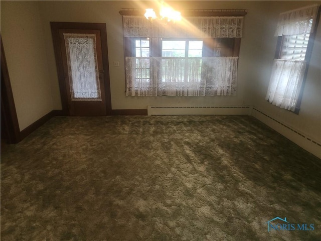 104 E S St, Middle Point, OH 45863 - unfurnished dining area with baseboard heating and carpet