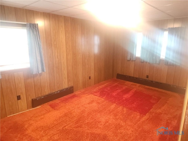 104 E S St, Middle Point, OH 45863 - carpeted empty room with a baseboard radiator and wooden walls