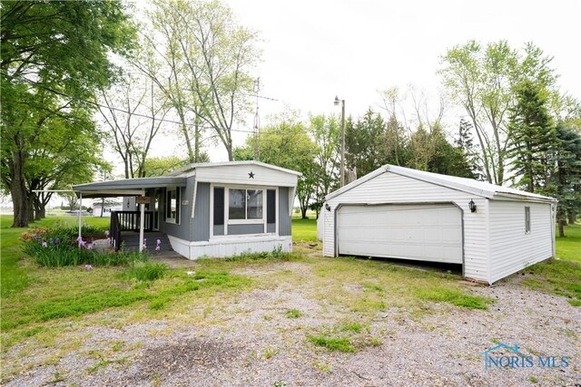 28916 Blanchard Rd, Defiance, OH 43512 - back of property featuring an outdoor structure, a garage, and covered porch