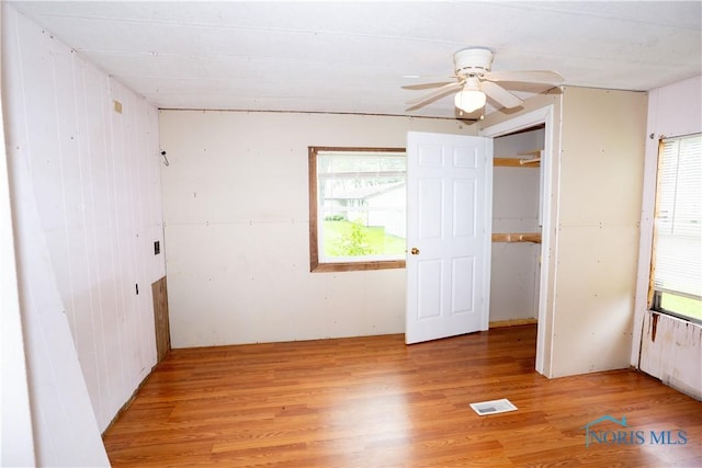 28916 Blanchard Rd, Defiance, OH 43512 - unfurnished bedroom with light wood-type flooring, a closet, and wooden walls