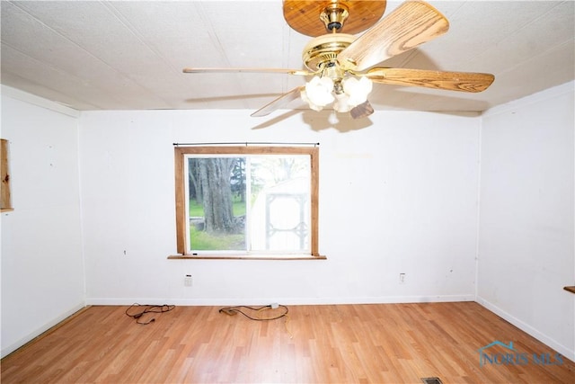 28916 Blanchard Rd, Defiance, OH 43512 - spare room with wood finished floors, a ceiling fan, and baseboards