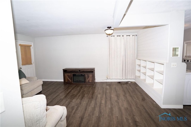 1618 S Clinton St, Defiance, OH 43512 - unfurnished living room with dark wood-style floors and baseboards