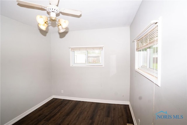 1618 S Clinton St, Defiance, OH 43512 - unfurnished room featuring plenty of natural light, baseboards, dark wood finished floors, and ceiling fan