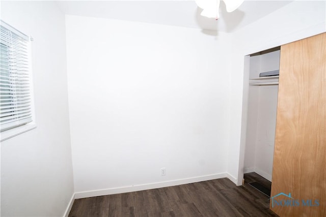 1618 S Clinton St, Defiance, OH 43512 - unfurnished bedroom with dark wood finished floors, a closet, and baseboards