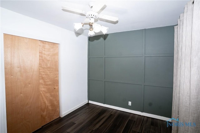 1618 S Clinton St, Defiance, OH 43512 - unfurnished bedroom with dark wood-type flooring, baseboards, ceiling fan, and a closet