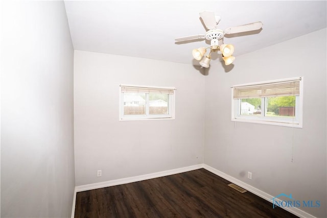 1618 S Clinton St, Defiance, OH 43512 - empty room with baseboards, dark wood-style floors, and a ceiling fan