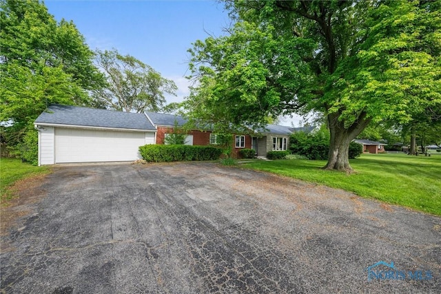 19330 N Dixie Hwy, Bowling Green, OH 43402 - ranch-style home with driveway, an attached garage, and a front yard
