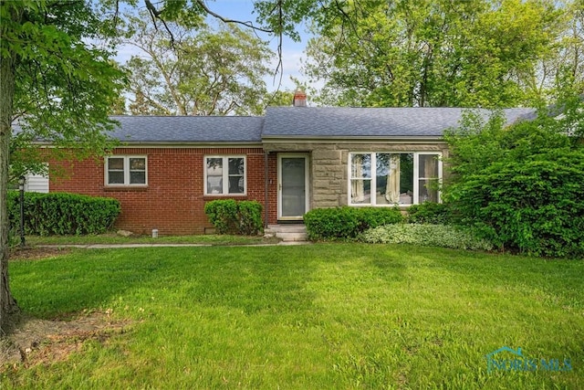 19330 N Dixie Hwy, Bowling Green, OH 43402 - ranch-style house featuring a front yard, brick siding, roof with shingles, and a chimney