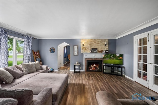 19330 N Dixie Hwy, Bowling Green, OH 43402 - living room featuring arched walkways, wood finished floors, baseboards, a lit fireplace, and crown molding