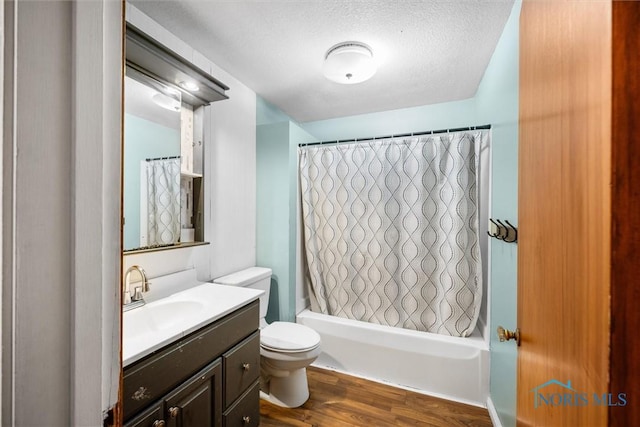 19330 N Dixie Hwy, Bowling Green, OH 43402 - full bath featuring vanity, toilet, wood finished floors, shower / tub combo with curtain, and a textured ceiling