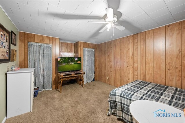 19330 N Dixie Hwy, Bowling Green, OH 43402 - bedroom with carpet floors, wooden walls, and ceiling fan