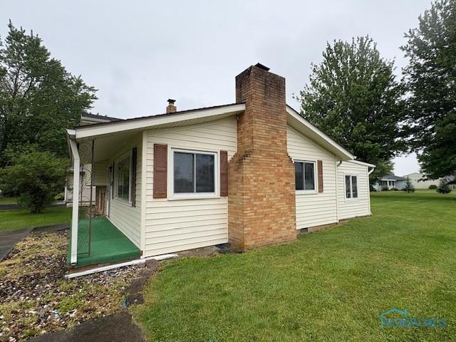 23695 E Second St, Grand Rapids, OH 43522 - view of property exterior with a chimney and a yard