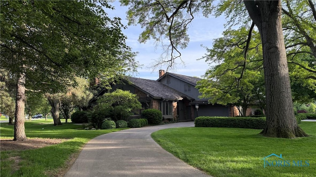 29802 Sussex Rd, Perrysburg, OH 43551 - view of front of property featuring curved driveway, a front lawn, and a chimney