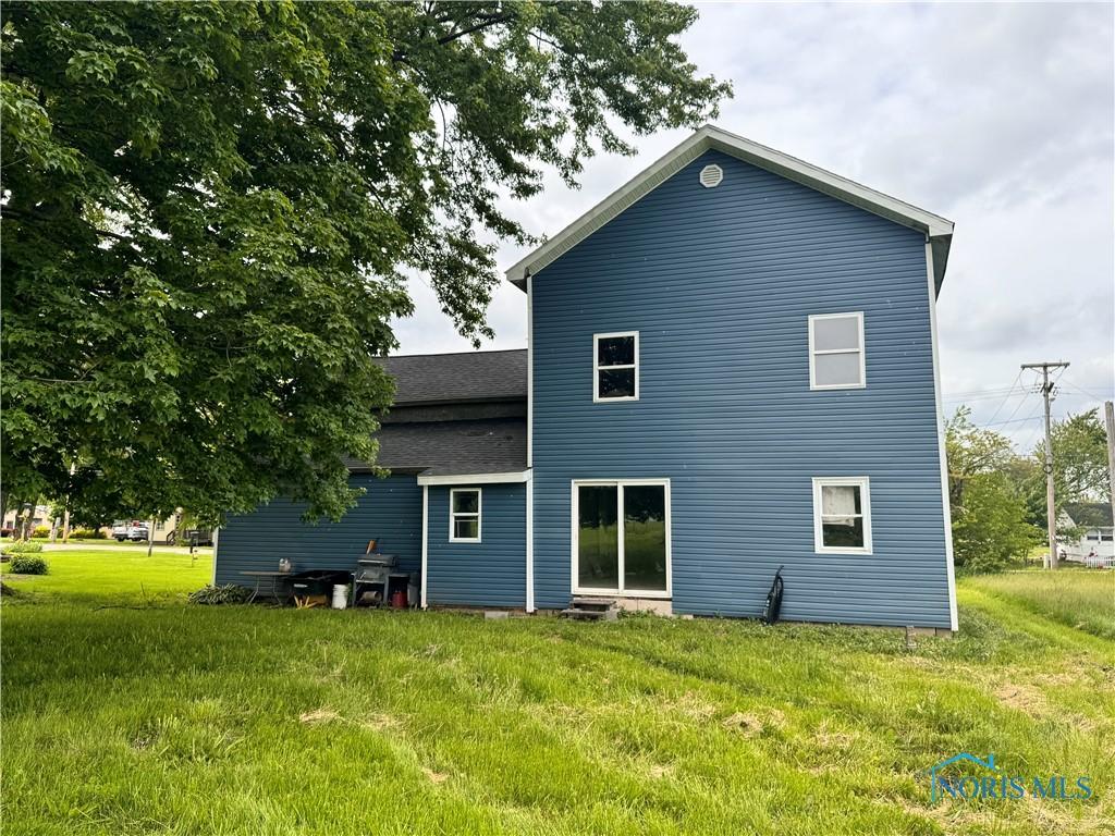 801 W Curtis St, Stryker, OH 43557 - back of house featuring a lawn