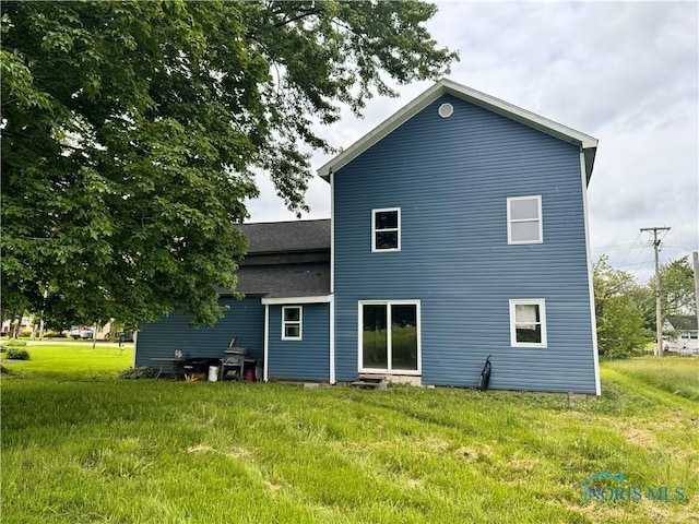 801 W Curtis St, Stryker, OH 43557 - back of house featuring a lawn